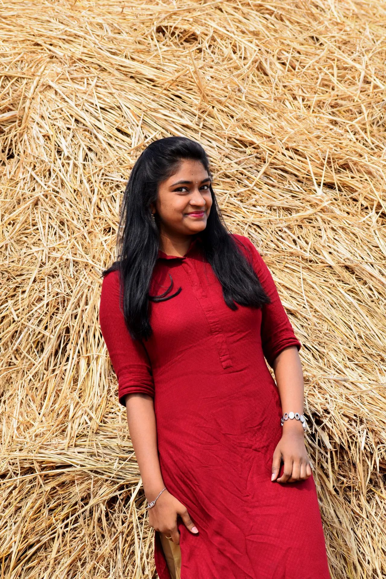 Vaishnavi smiling in a red kurta